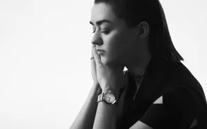Caption: Maisie Williams Striking A Pose In An Elegant Outfit Wallpaper