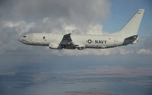 Caption: Majestic Boeing P-8 Poseidon In Mid-flight Wallpaper