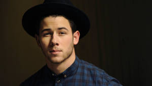 Caption: Nick Jonas Exudes Coolness In A Checkered Polo. Wallpaper