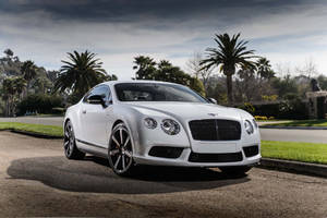 Caption: Pristine White Bentley With Shimmering Silver Rims Wallpaper