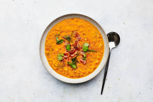 Caption: Savory Red Lentil Soup Garnished With Spice Wallpaper