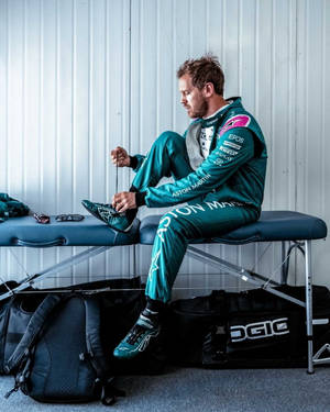 Caption: Sebastian Vettel Relaxing On A Bench Wallpaper