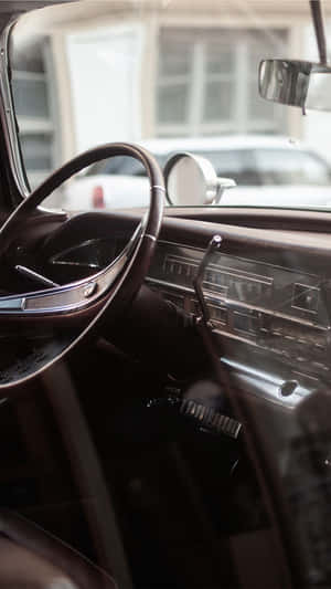 Caption: Stunning Classic Car Displayed On An Iphone Screen Wallpaper