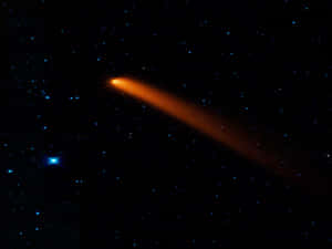 Caption: Stunning Comet Illuminating The Night Sky Wallpaper