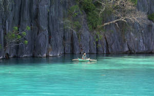 Caption: Stunning Views Of The Crystal Clear Waters In The Philippines Wallpaper