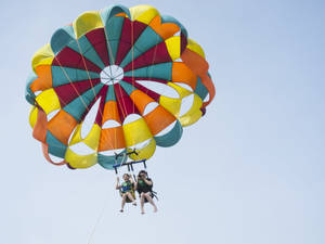 Caption: Thrilling Adventure Of Parasailing In The Middle East Wallpaper