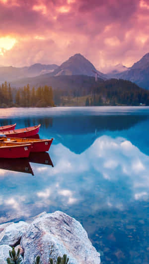 Caption: Tranquil Scene - Boats On Lake At Sunset Wallpaper