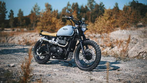 Caption: Triumph Scrambler Bobber Motorcycle In Its Pristine Glory Wallpaper