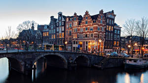 Caption: Vibrant Scene Of Amsterdam's Red Light District Wallpaper