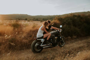 Caption: Young Love - Couple Enjoying A Beautiful Sunset Wallpaper