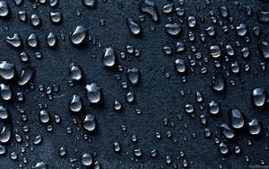 Captivating Close-up Of Dark Water Droplets Wallpaper