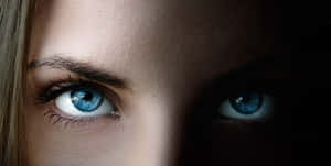 Captivating Closeup Of Woman's Blue Eye Wallpaper