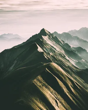 Captivating Summit: Embrace The Majesty Of Nature Wallpaper