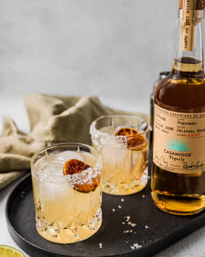 Casamigos Tequila Reposado Liquor Bottle And Margarita Drinks Wallpaper