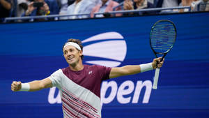 Casper Ruud Smiling While Holding Racket Wallpaper