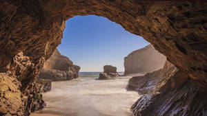 Cave In Foggy Beach Wallpaper