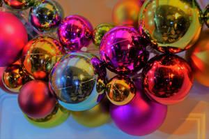 Celebrate The Joyous Season With Shiny Christmas Ornaments Wallpaper