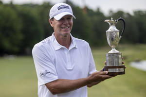 Champion Golfer Steve Stricker Holding His Trophy Wallpaper