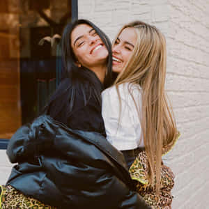 Charli And Addison Hugging Each Other Wallpaper
