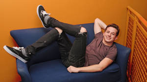 Charlie Puth Lying Down Joyfully Wallpaper