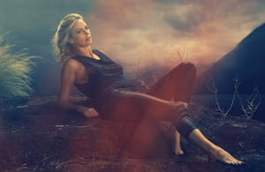 Charlize Theron Posing On A Mountain Wallpaper