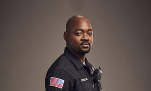 Charming Black Man Showcasing Confident Elegance Wallpaper