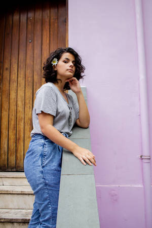 Cheerful Latina Girl By A Vintage Doorway Wallpaper