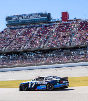 Chris Buescher'a Ford Mustang Roaring On The Track Wallpaper