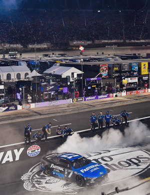 Chris Buescher Competing In A High-speed Car Race Wallpaper