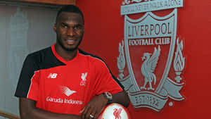 Christian Benteke Against Liverpool Fc Logo Wallpaper