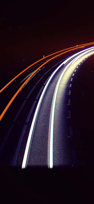 City Streetlight Illuminating An Empty Nighttime Street Wallpaper