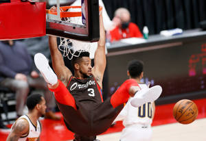 Cj Mccollum Hanging On The Rim Wallpaper