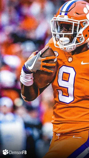 Clemson Tigers Football Player Running With A Ball Wallpaper