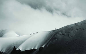 Climbing A Treacherous Mountain Side Wallpaper