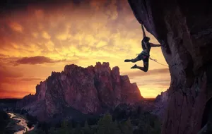 Climbing Female With Setting Sun Wallpaper