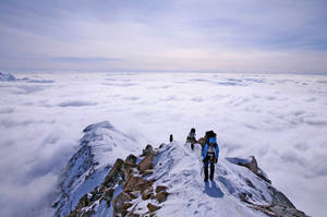 Climbing Group Of Three Men Wallpaper