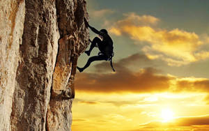 Climbing Silhouette Of A Man Wallpaper