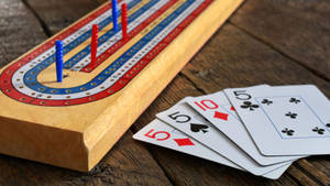 Close-up Cribbage Board Cards Beside Wallpaper