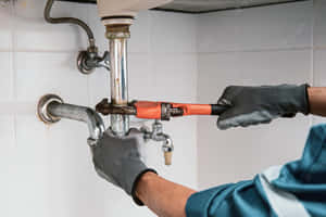 Close Up Plumber Fixing Plumbing System Wallpaper