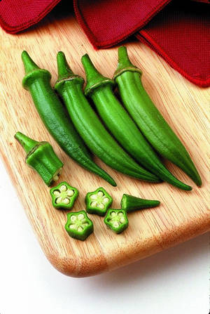 Cloth And Okras On Chopping Board Wallpaper