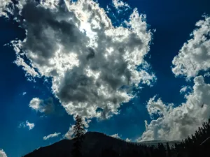 Clouds Above Snow Capped Mountains Wallpaper