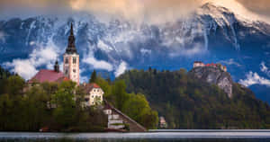Clouds Reaching The Julian Alps Behind Lake Bled Wallpaper