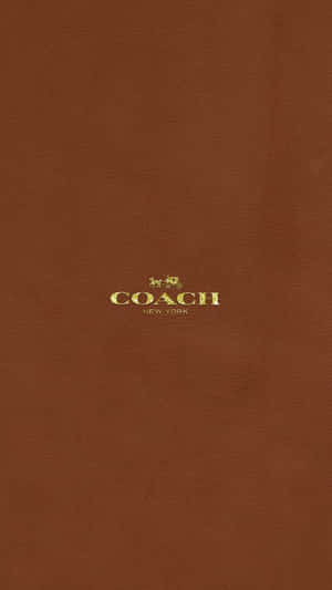 Coach Logo On A Brown Background Wallpaper