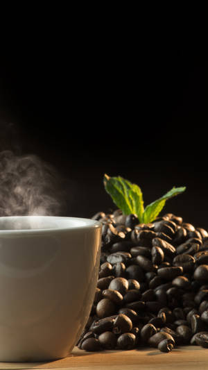 Coffee Cup Next To Coffee Beans Wallpaper