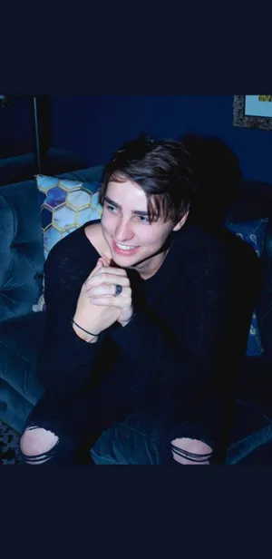 Colby Brock Stands Strong Against A Pink Sky Wallpaper