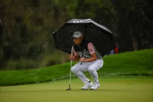 Collin Morikawa Under An Umbrella Wallpaper