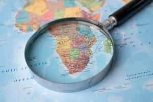 Colorful World Map And Magnifying Glass Wallpaper