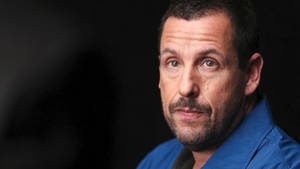 Comedian Adam Sandler In Pensive Mood Wallpaper