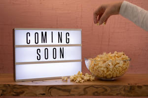 Coming Soon Hand Taking Popcorn Wallpaper