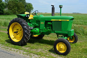 Compact Yet Powerful John Deere Tractor In Action Wallpaper